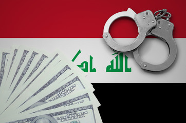 Iraq flag  with handcuffs and a bundle of dollars. The concept of illegal banking operations in US...