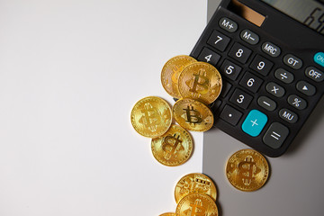 Cryptocurrency coins (Bitcoin and Ethereum) over calculator.