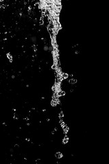 water jet with spray on a black background
