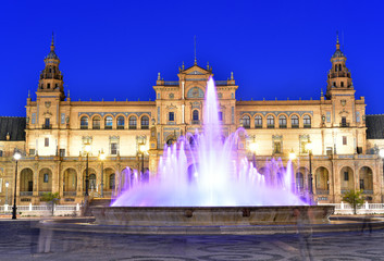 Night view over Plaza de Espana with illuminated fountain and Cntral Palace , Seville, Andalusia, Spain