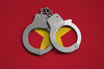 Vietnam flag  and police handcuffs. The concept of observance of the law in the country and...