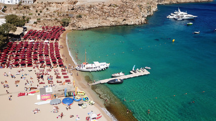 Aerial drone, bird's eye view photo of iconic and famous crowded beach of Super Paradise with sapphire clear waters, Mykonos island, Cyclades, Greece - obrazy, fototapety, plakaty