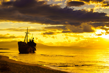 Rusty broken shipwreck on sea shore