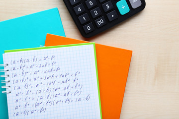 Exercise book with maths formulas and calculator