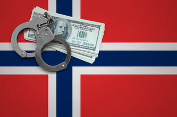 Norway flag  with handcuffs and a bundle of dollars. The concept of breaking the law and thieves...