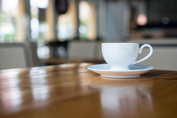 Hot art coffee cappuccino in a cup on wooden table background  with copy space