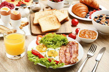 Tasty breakfast on wooden table