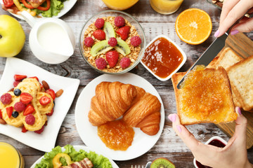 Tasty breakfast on wooden table