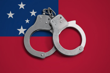 Samoa flag  and police handcuffs. The concept of observance of the law in the country and...