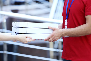 Delivery man with pizza in cardboard boxes