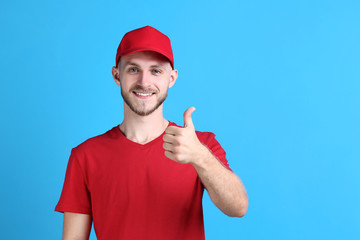 Delivery man in red uniform on blue background