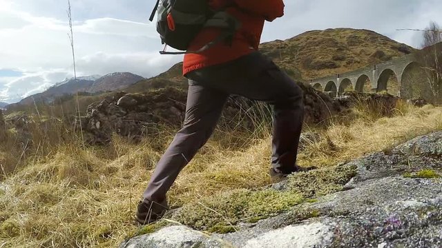 4K footage of a traveler going by the path in Scottish Glenfinnan