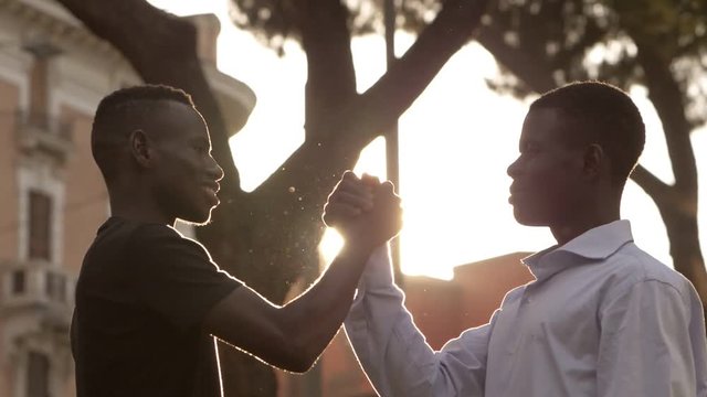 ethnic identity. Greeting Among young African friends at the park
