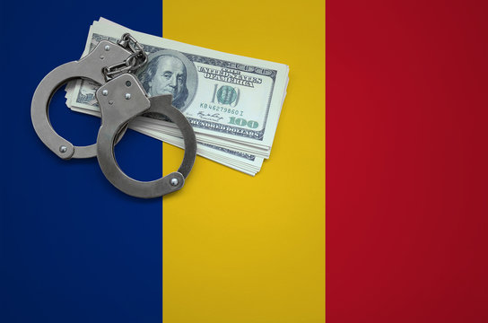 Romania flag  with handcuffs and a bundle of dollars. The concept of breaking the law and thieves crimes