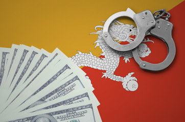 Bhutan flag  with handcuffs and a bundle of dollars. The concept of illegal banking operations in...