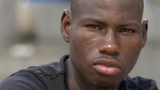 thoughtful sad attractive young black african man looking at the camera