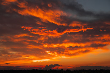 Beautiful fiery, orange and red, sunset sky. Evening Magic Scene. Composition of nature