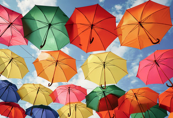 Lots of colorful umbrellas in the sky. City decoration