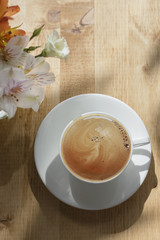 Cup of Morning Coffee with Flowers on Wood Back