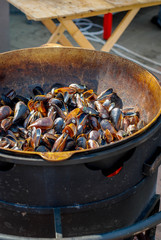 mussels are fried on a brazier