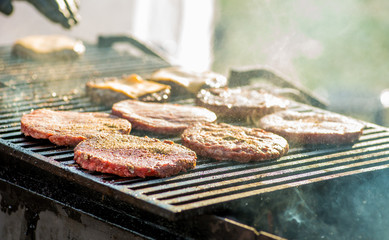 guy cooks grilled burger cutlets. Street food