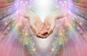 Energy healer receiving high vibrational energy - female cupped hands and shaft of white light...