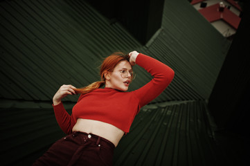 Fashion portrait of redhaired sexy girl on roof. Model attractive seduction woman.