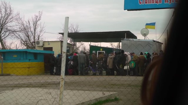 A long shot of people receiving relief goods.