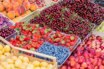 Fruits, berries and vegetables on the counter at the street market.
