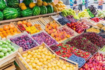 Fruits, berries and vegetables on the counter at the street market.