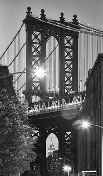 Black and white picture of the Manhattan Bridge seen from Dumbo, neighborhood of Brooklyn at dusk, New York City, USA.