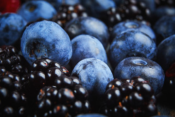fresh blueberries and blackberryes on a dark background