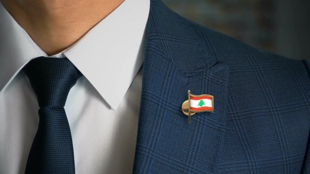 Businessman Walking Towards Camera With Country Flag Pin - Lebanon