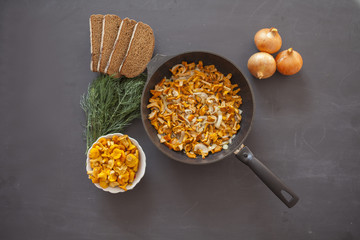 Boiled potatoes with fried mushrooms chanterelles in a frying pan