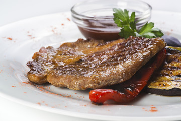 Baked  pork chop served with grilled vegetables