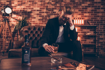 Sad unhappy upset disappointed crying troubled virile freelancer drinking alcohol beverage smoking...