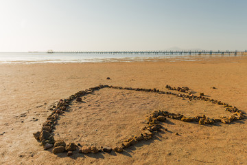 heart shape from stones at sea coast landscape