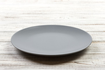Perspective view. Empty Gray round plate on wooden background