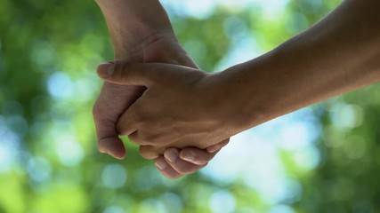 Two homosexual men joining hands, romantic relations, date outdoor, togetherness