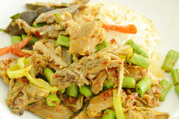 spicy fried duck meat curry with basil leaf and rice on plate
