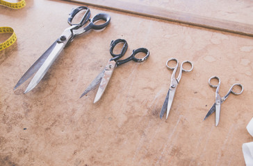 Scissors of different sizes on the tailor table