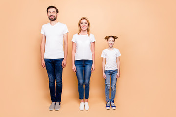 Full length portrait of cheerful smiling bearded father and blonde happy mother standing straight...