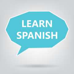 learn spanish written on speech bubble- vector illustration