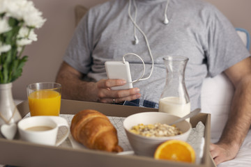 Man listening to the music in bed