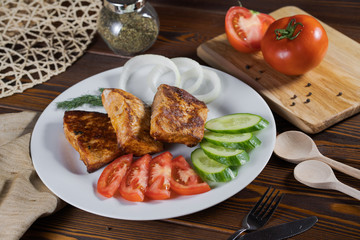 Grilled skewers on the plate made with chicken, bacon and vegetables