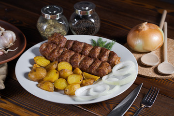 Grilled skewers on the plate made with chicken, bacon and vegetables