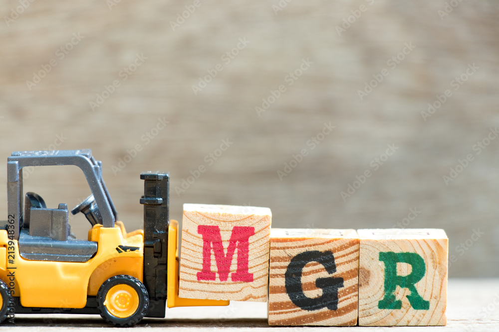 Poster Toy forklift hold letter block m in word mgr (abbreviation of manager) on wood background