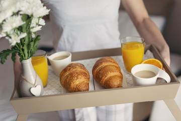 Woman holding a breakfast tray