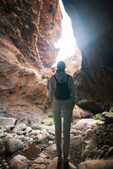 Silhouette of traveler woman in mountain cave