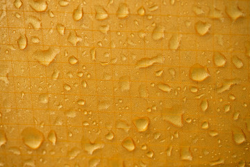 Raindrops, closeup, on a background tent.